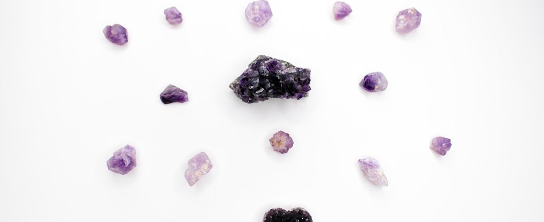 Decorative photo of amethyst crystals laid out on a table